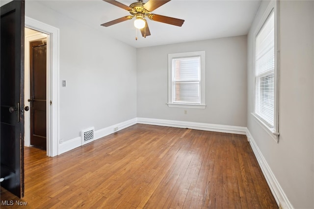 unfurnished room with light wood-type flooring, a wealth of natural light, and ceiling fan