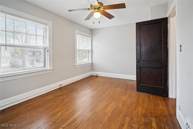 spare room featuring wood-type flooring and ceiling fan