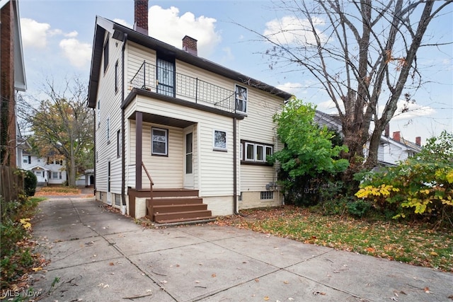 rear view of property featuring a balcony