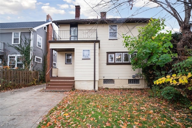 back of property with a balcony