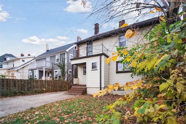 back of property with a balcony