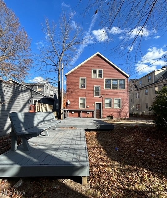 back of property featuring a wooden deck