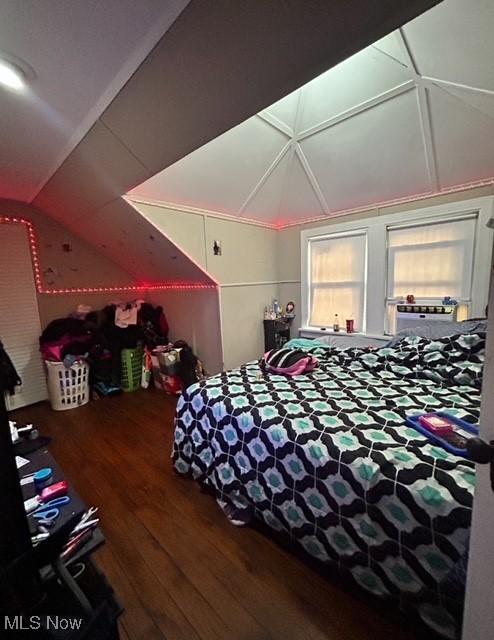 bedroom featuring lofted ceiling and hardwood / wood-style flooring