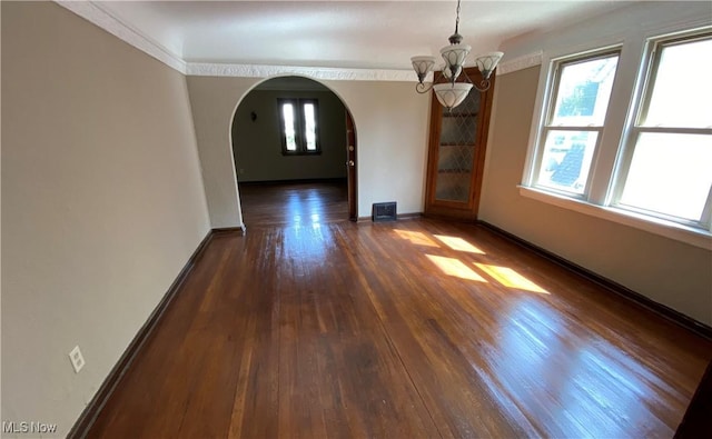 interior space with ornamental molding, dark hardwood / wood-style floors, and a notable chandelier