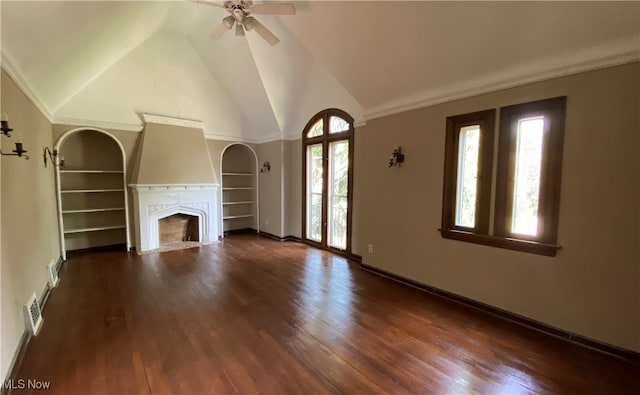 unfurnished living room featuring dark hardwood / wood-style floors, ceiling fan, a wealth of natural light, and vaulted ceiling