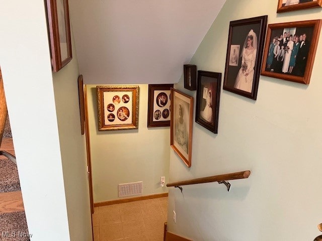 staircase featuring vaulted ceiling