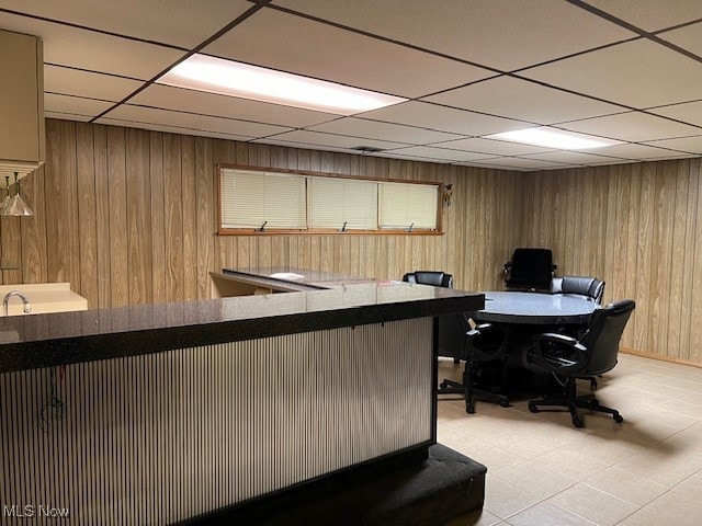 interior space with wood walls, bar area, and a paneled ceiling