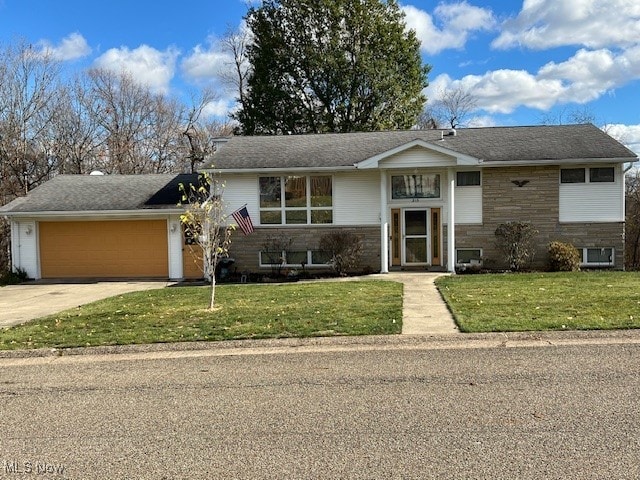 view of front facade with a front lawn and a garage