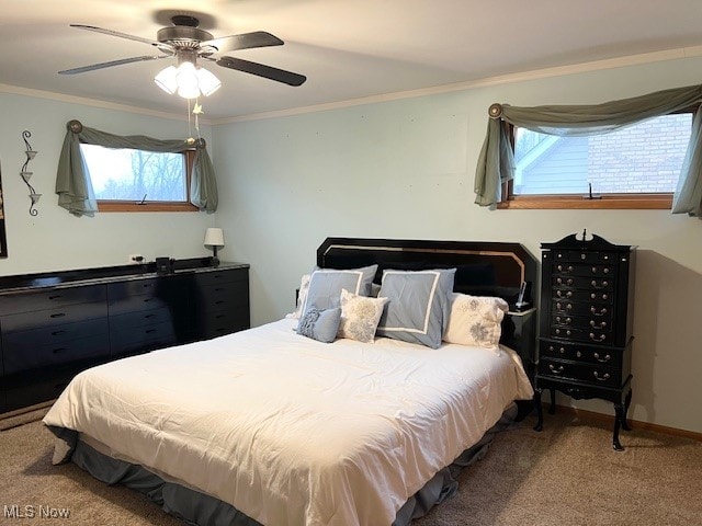 bedroom with carpet flooring, ceiling fan, and crown molding