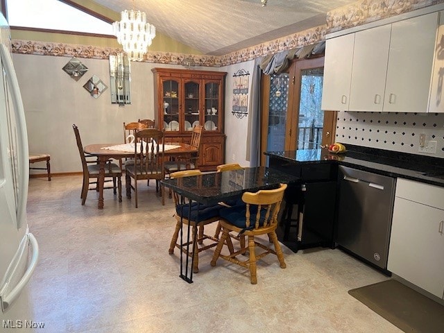 kitchen with white cabinetry, lofted ceiling, dishwasher, and white fridge