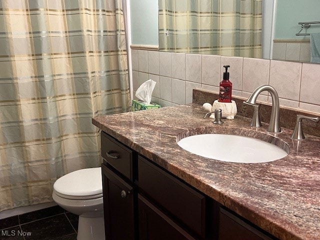 bathroom featuring tile walls, vanity, tile patterned floors, toilet, and decorative backsplash