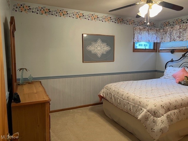 bedroom featuring light colored carpet and ceiling fan