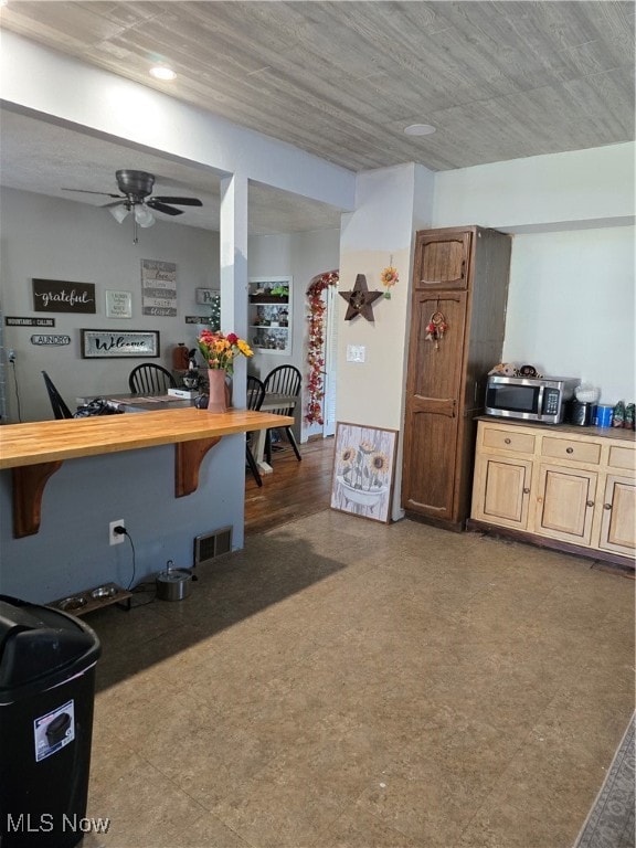 kitchen featuring light brown cabinetry and ceiling fan