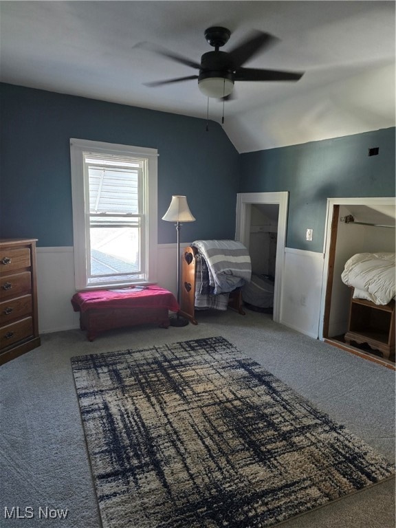 bedroom featuring carpet floors, lofted ceiling, and ceiling fan