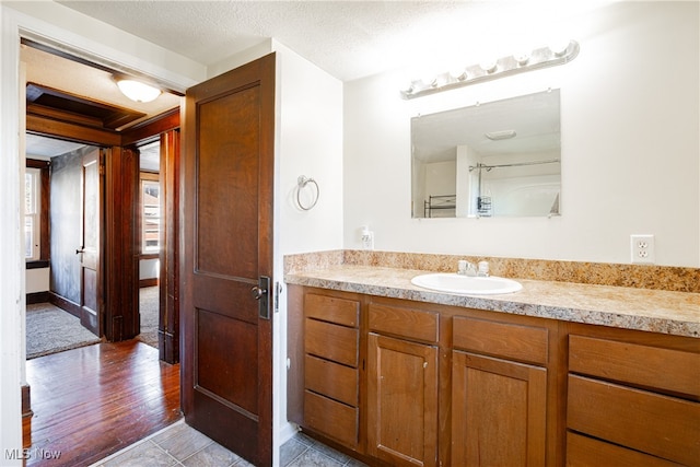 bathroom featuring vanity, a textured ceiling, and hardwood / wood-style flooring