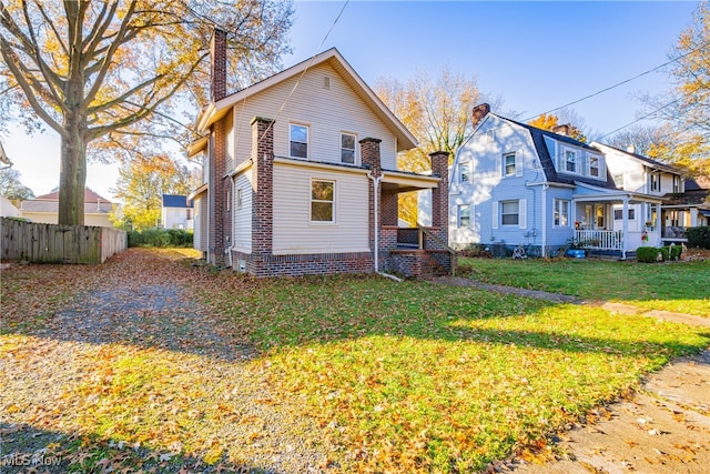 view of front of home with a porch and a front lawn