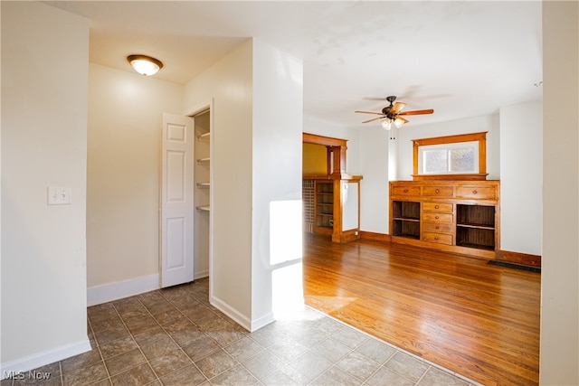 interior space with hardwood / wood-style floors and ceiling fan