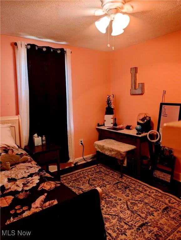 bedroom featuring ceiling fan and a textured ceiling