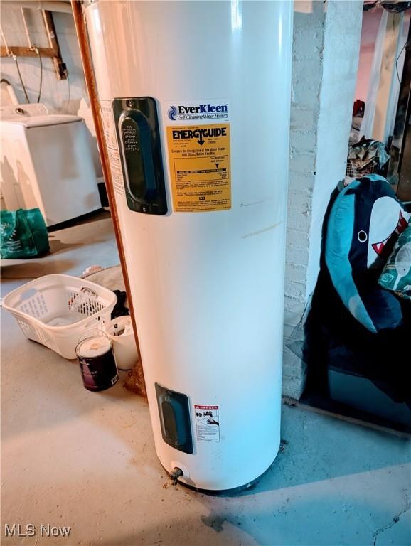 utility room featuring washer / dryer and electric water heater