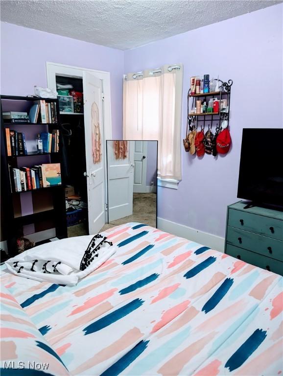 bedroom with a closet and a textured ceiling