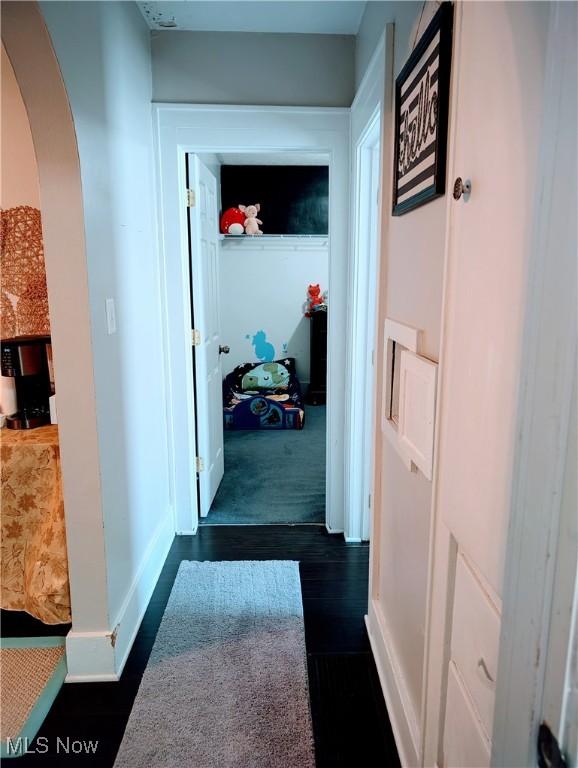 corridor featuring dark wood-type flooring