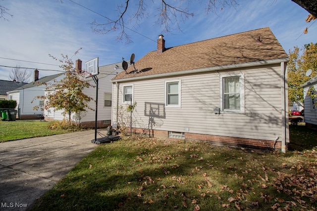 view of side of home featuring a yard