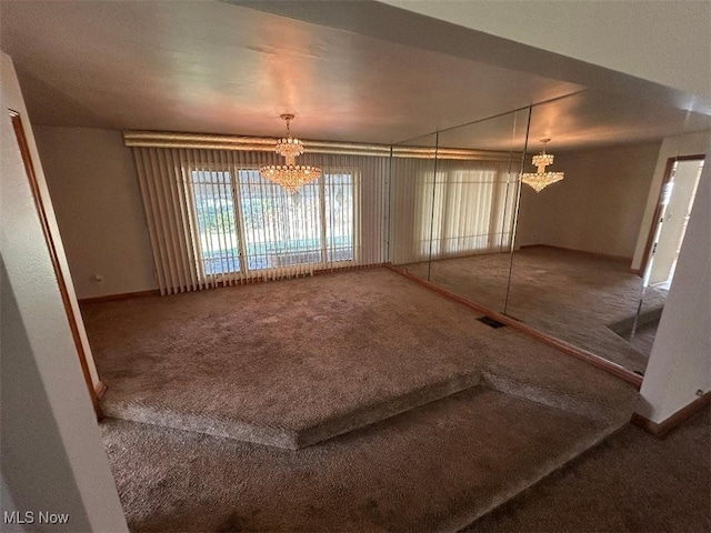 unfurnished dining area with a chandelier and carpet flooring