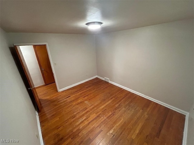 spare room featuring hardwood / wood-style flooring