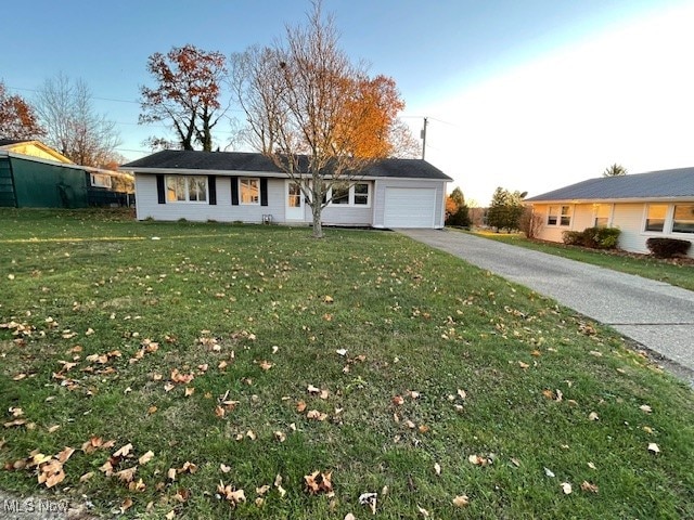 ranch-style home featuring a garage and a front yard