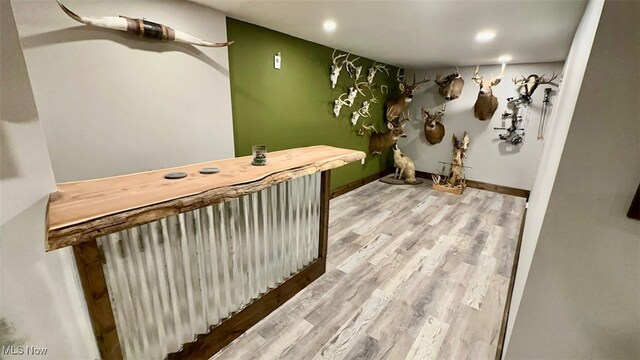 interior space featuring bar and wood-type flooring