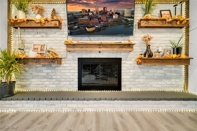 interior details featuring a fireplace and wood-type flooring