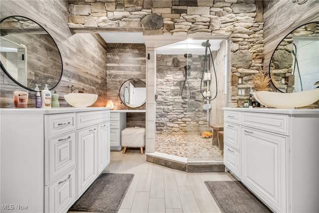 bathroom with vanity, a shower, and wood-type flooring