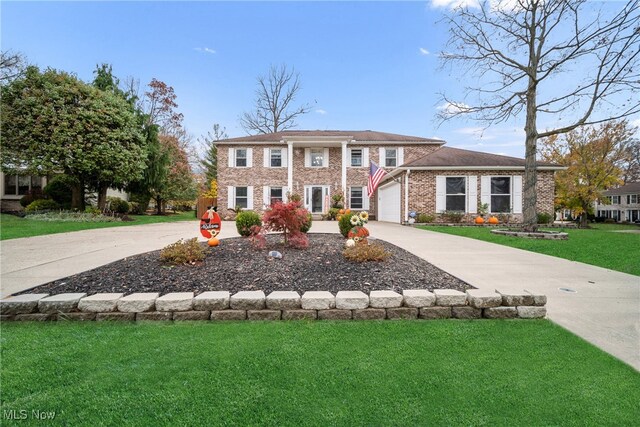 view of front facade featuring a front yard and a garage