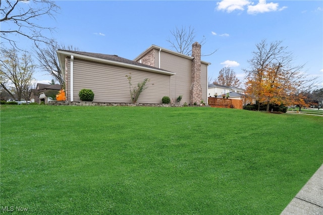 view of home's exterior with a lawn