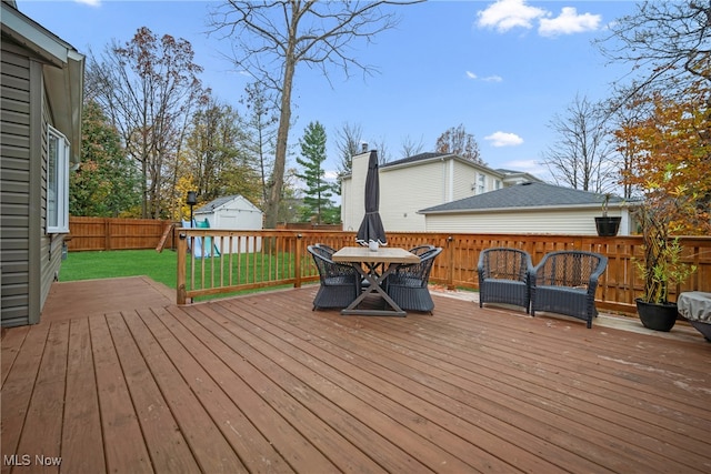 wooden deck with a yard and a shed