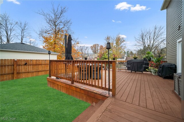 deck with a yard and area for grilling