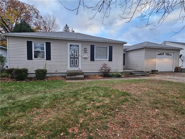 view of front of property with a garage and a front yard