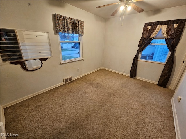 spare room featuring ceiling fan and carpet