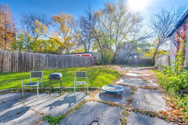 view of yard with an outdoor fire pit and a patio area