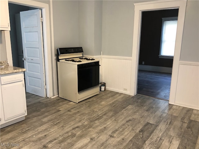 kitchen with white cabinetry, dark wood-type flooring, and white range