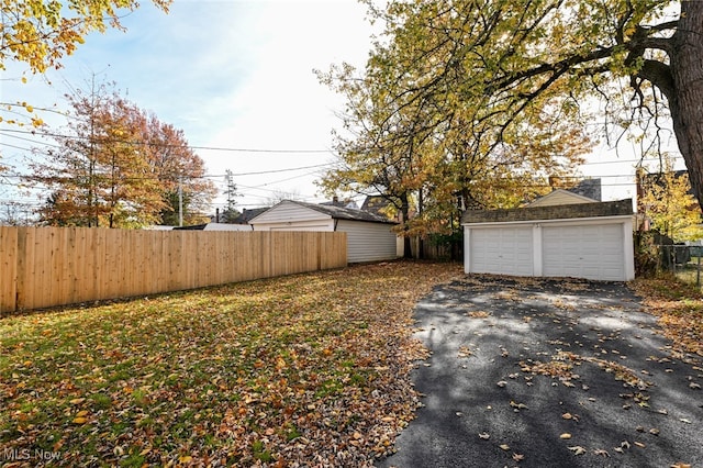 view of yard with an outbuilding and a garage