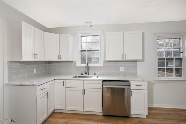 kitchen with dishwasher, white cabinets, a wealth of natural light, and sink