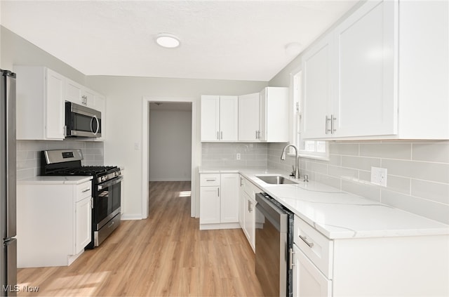 kitchen with white cabinets, sink, and stainless steel appliances