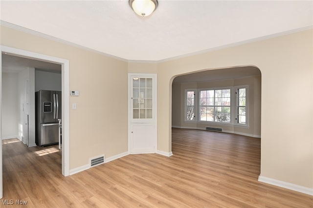 unfurnished room with crown molding and hardwood / wood-style floors