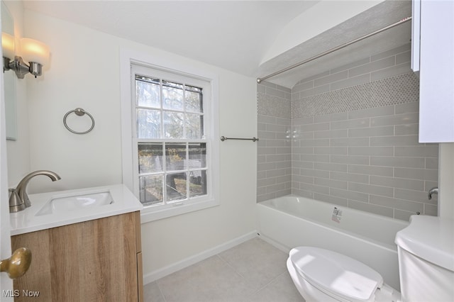 full bathroom featuring vanity, tile patterned floors, tiled shower / bath, vaulted ceiling, and toilet