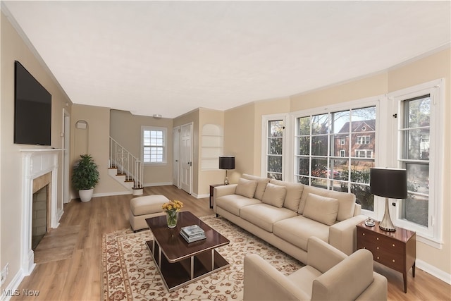 living room featuring plenty of natural light and light hardwood / wood-style flooring