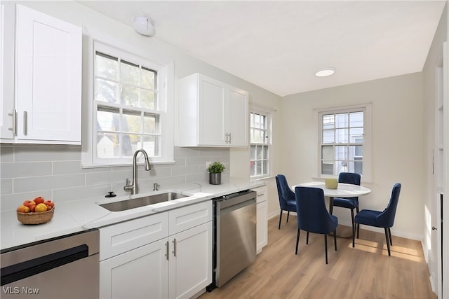 kitchen featuring dishwasher, plenty of natural light, and sink