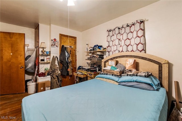 bedroom with dark wood-type flooring