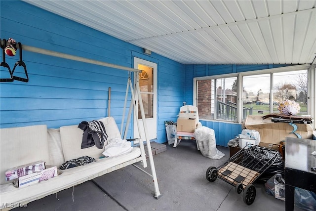 sunroom featuring vaulted ceiling