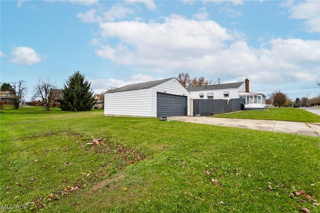 view of yard featuring an outbuilding and a garage